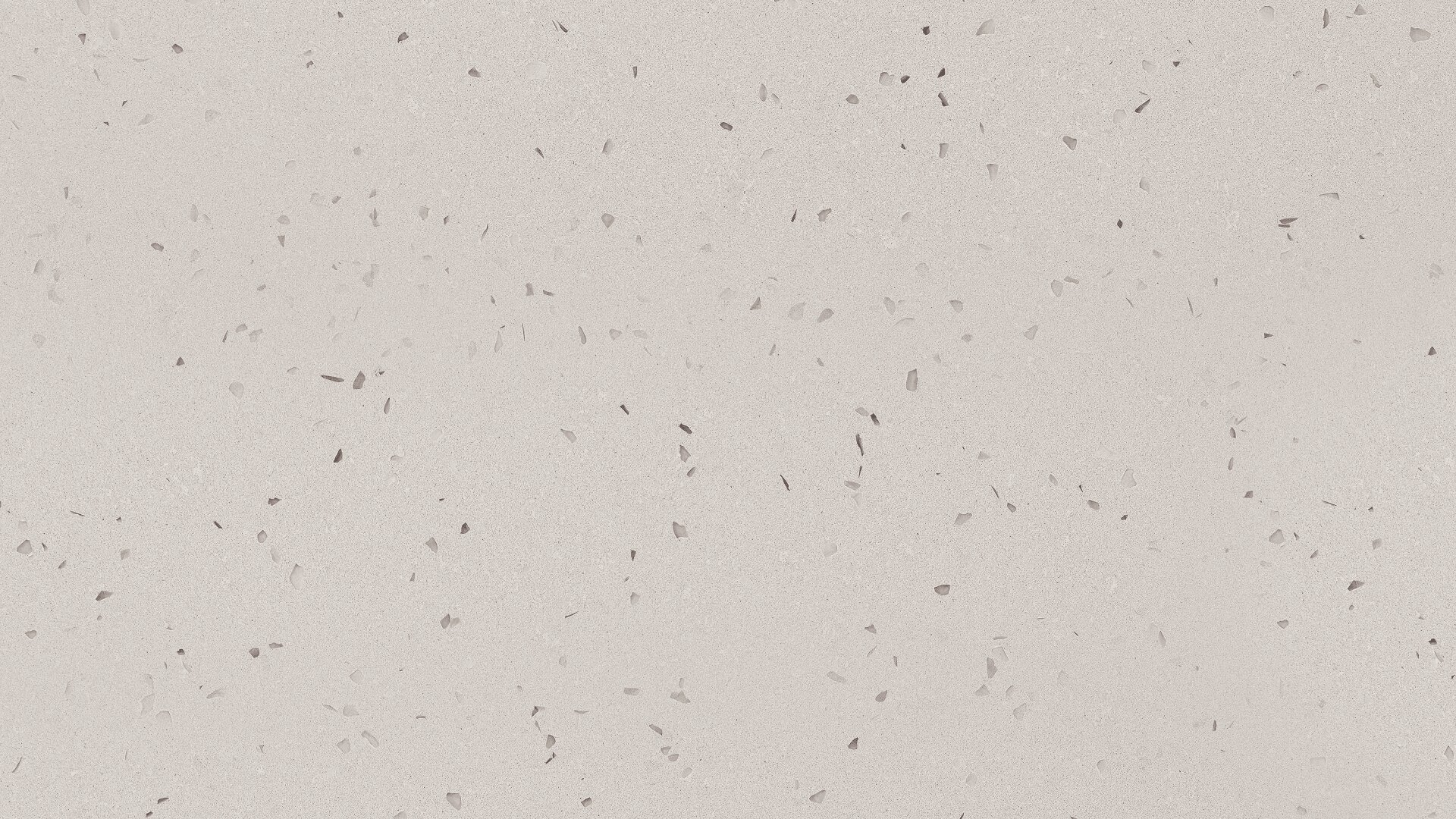 Glatte, gebrochen weiße Oberfläche, die mit kleinen, unregelmäßigen grauen und hellbraunen Flecken übersät ist, die einem Terrazzo- oder Sprenkelsteinmuster ähneln.
