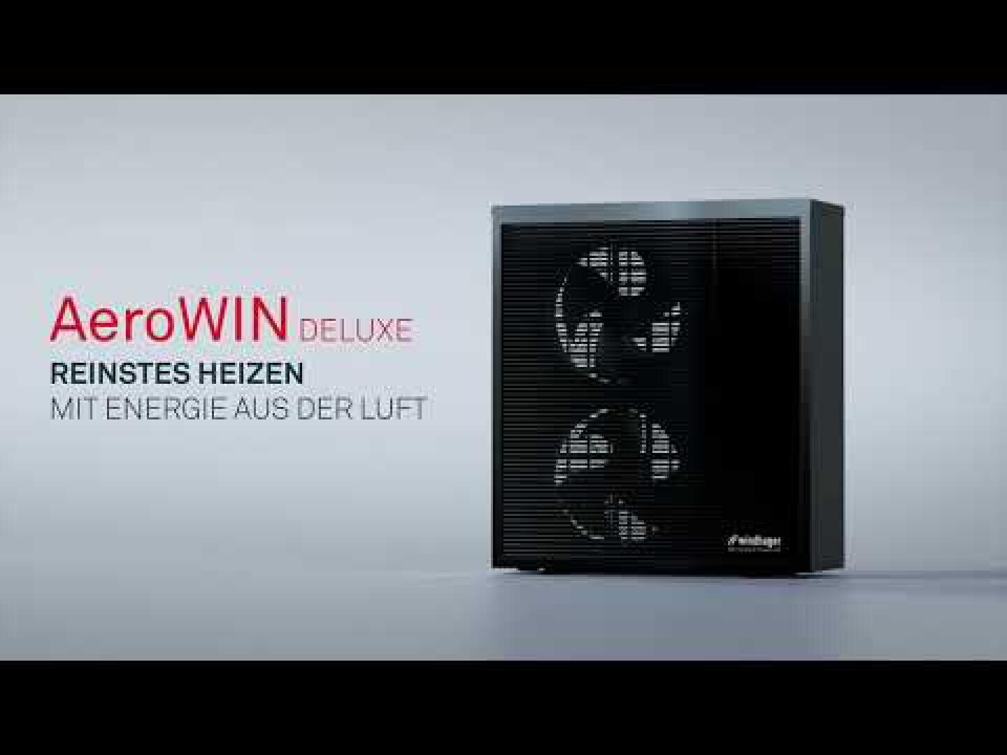 Eine schwarze AeroWIN Deluxe Wärmepumpe steht auf einer hellen Fläche. Der deutsche Text lautet: AeroWIN Deluxe. Reinstes Heizen. Mit Energie aus der Luft.