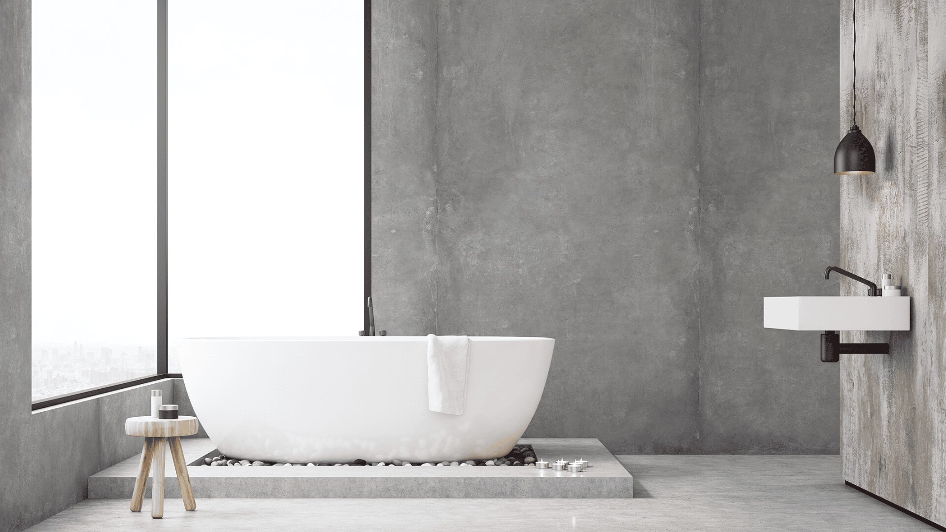 Ein modernes Badezimmer mit einer großen weißen Badewanne auf einem Steinpodest, einem kleinen Holzhocker mit Toilettenartikeln, einem weißen Waschbecken und raumhohen Fenstern mit Blick auf die Stadt. Die Einrichtung ist minimalistisch mit grauen Betonwänden.