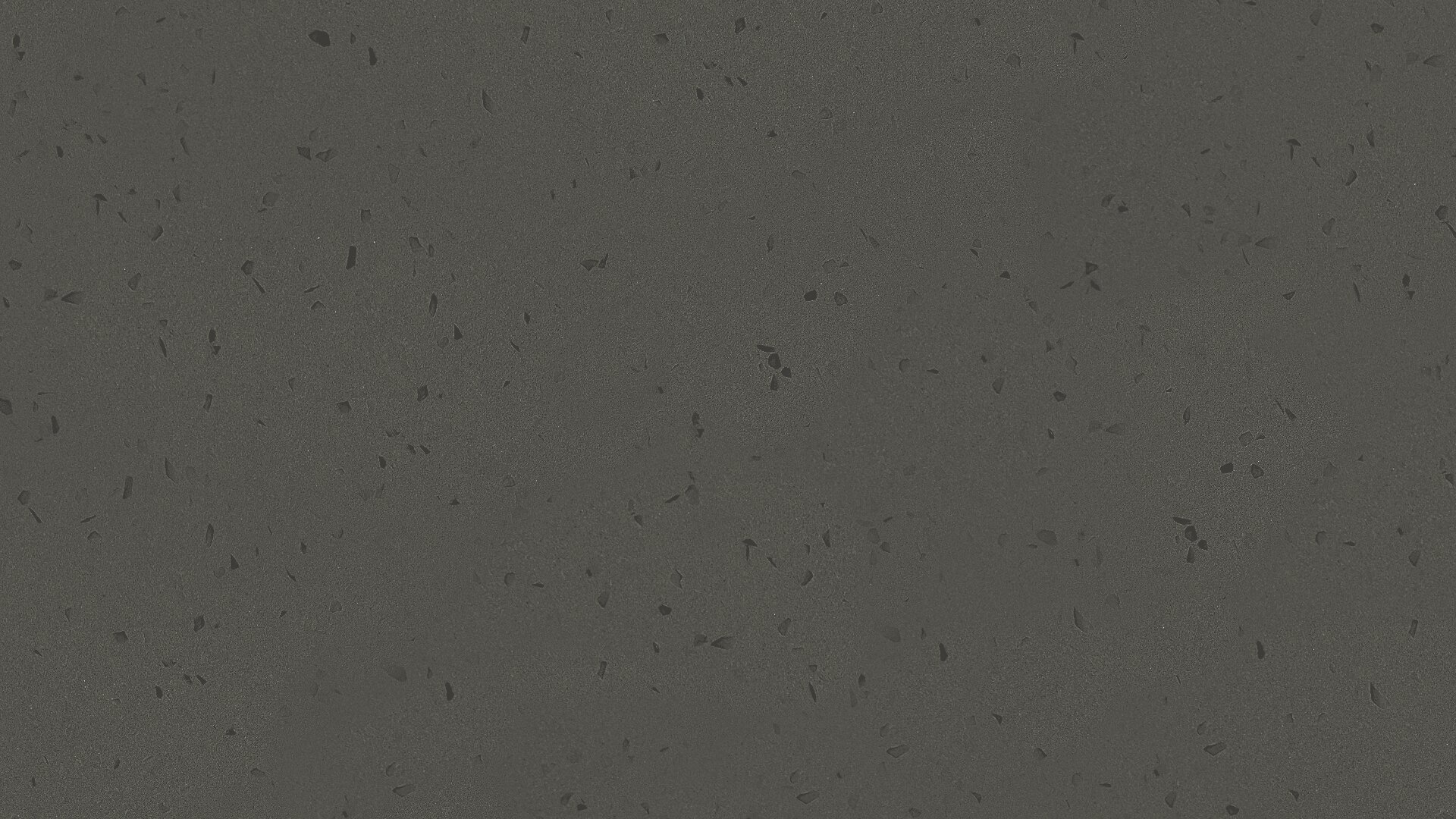 Dunkelgraue Steinoberfläche mit vereinzelten kleinen schwarzen Flecken und subtilen Strukturmustern, die einer Arbeitsplatte aus Beton oder Terrazzo ähnelt.