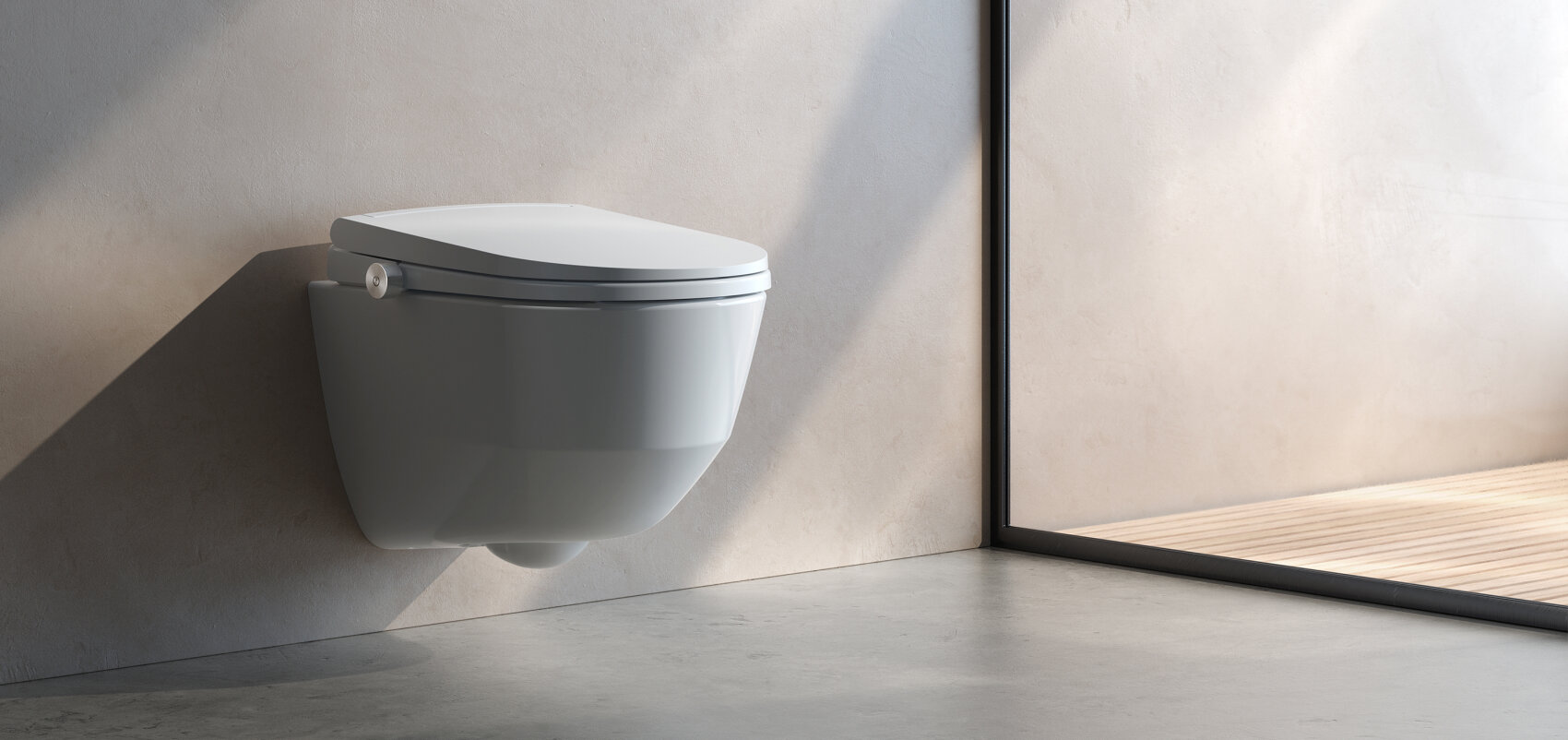 Des toilettes murales blanches et modernes dans une salle de bains minimaliste aux murs et aux sols neutres, à côté d'une grande fenêtre qui laisse entrer la lumière naturelle.